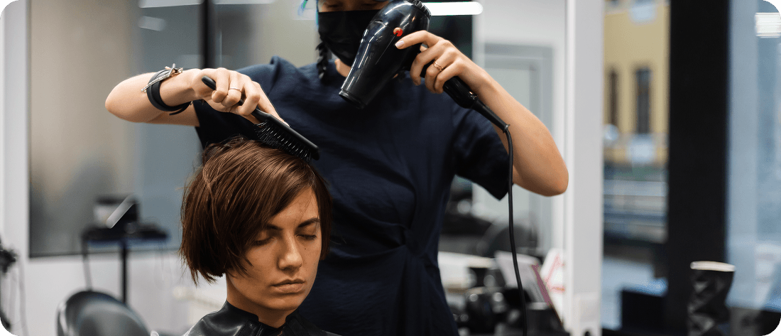 Hairdresser working on client's hair